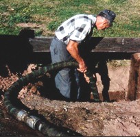 Man Cleaning Out Cesspool Image